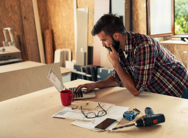 iStock-840979094 - builder carpenter man young laptop indoors check.jpg 1